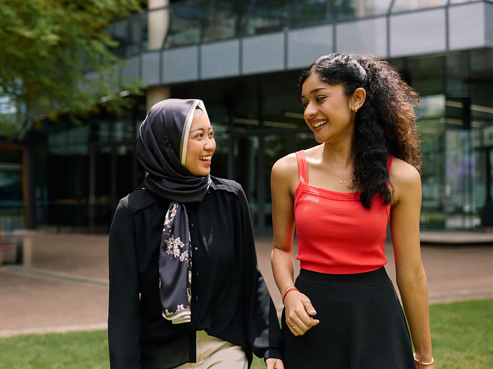 Two people walking through campus