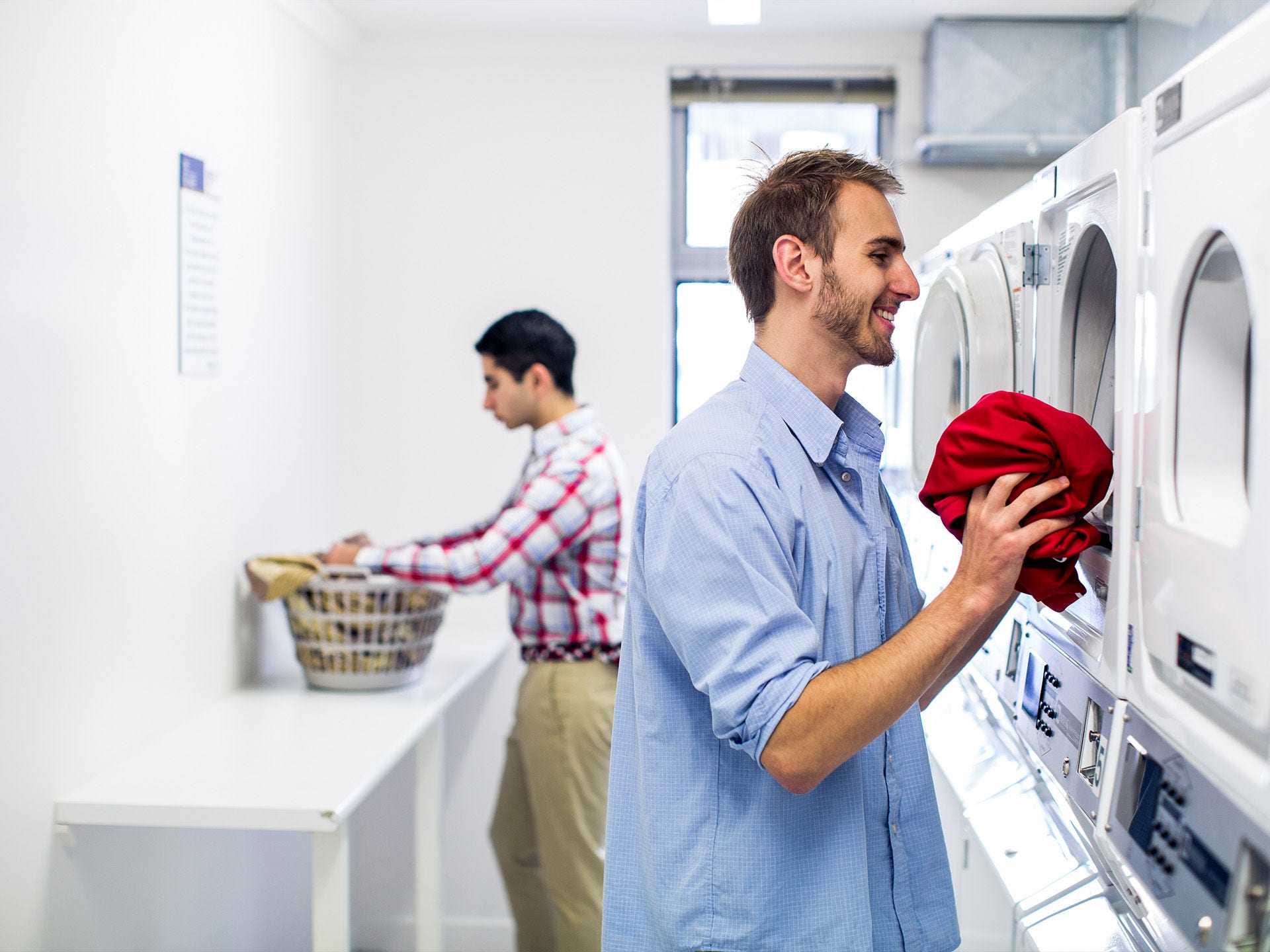 Residents using the laundry facilities at Adelaide University Village student accommodation