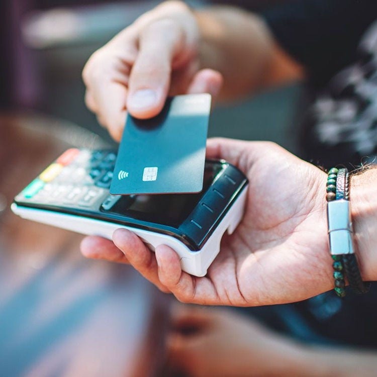 Someone taps a card on an EFTPOS