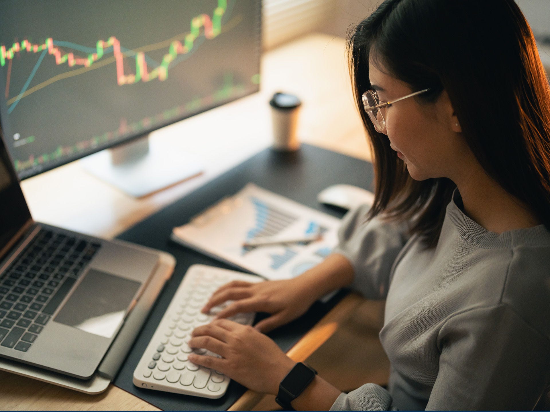 Person at a laptop with economic data