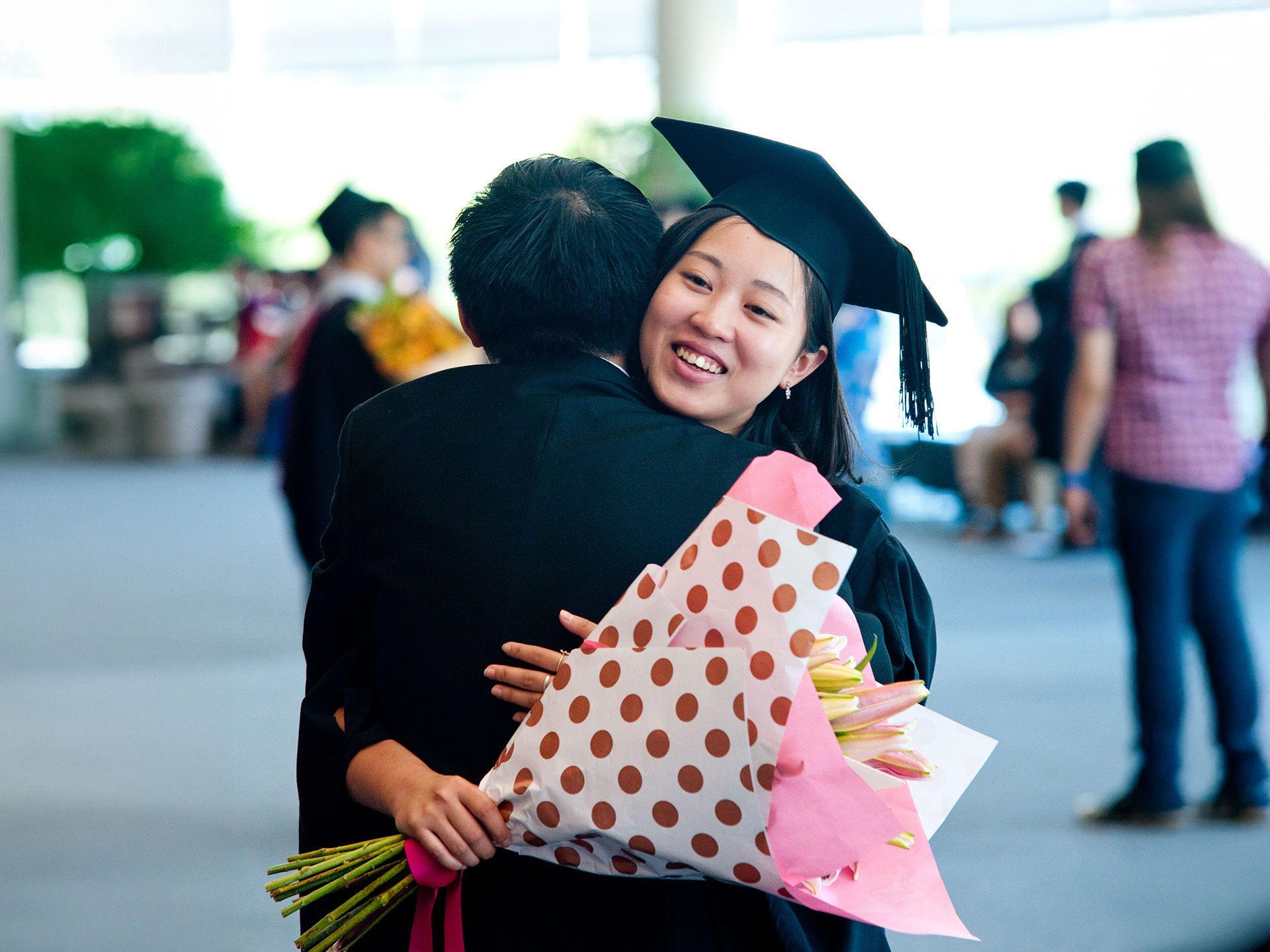 Two people hugging at graduation