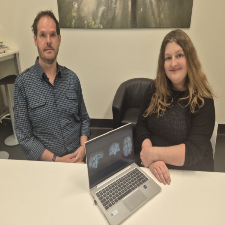 Researcher and study participant sitting at desk.