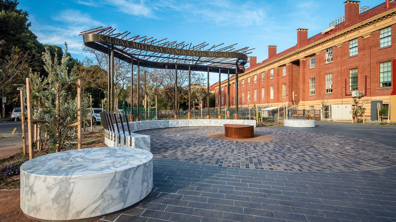 Kaurna Learning Circle on Adelaide University grounds with sandstone building in background