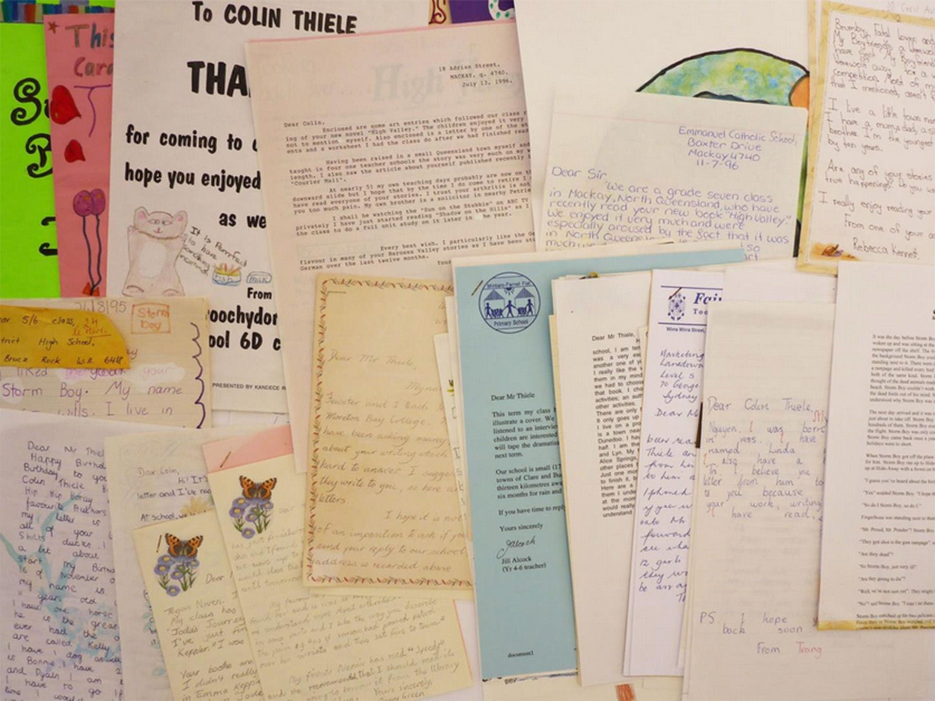 A collection of manuscripts and personal papers showing written letters and different coloured papers.