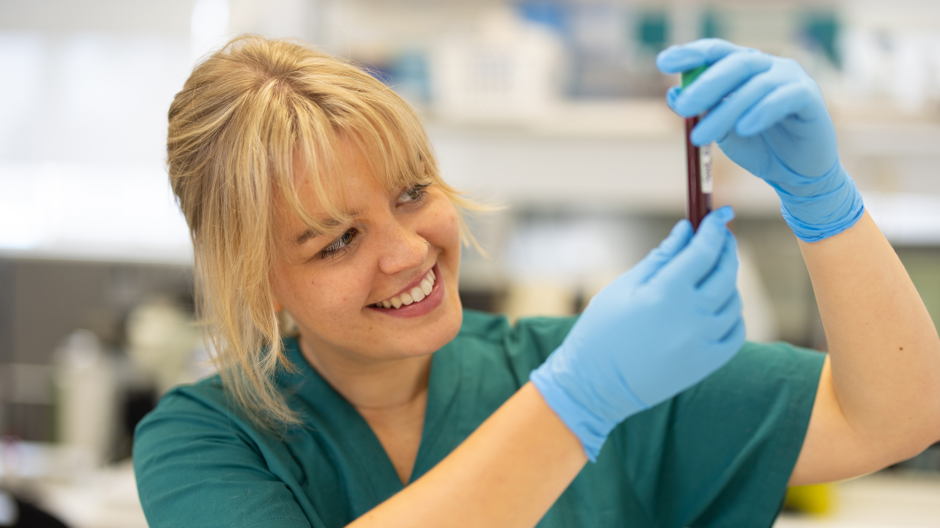 a vetinary student examining a blood sample