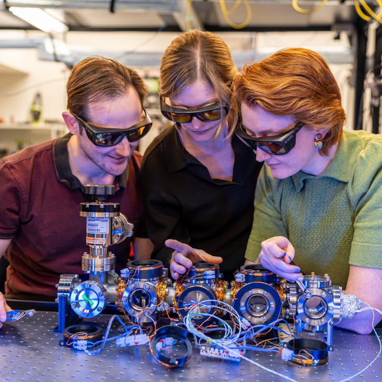 Dr Ashby Hilton, Dr Elizaveta (Liz) Klantsataya and Dr Sarah Watzdorf working on a prototype of a next-generation portable atomic clock.
