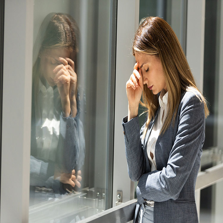 A female worker looking visibly stressed at work