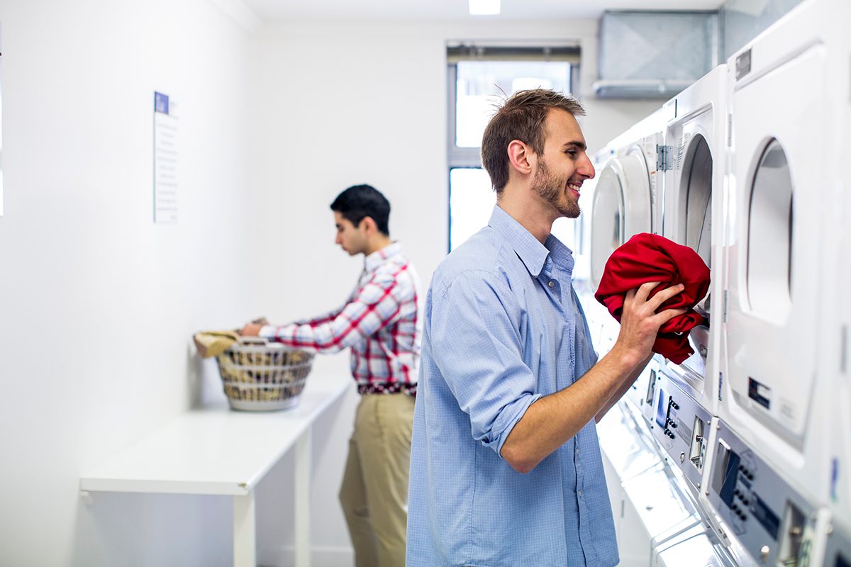 Residents using the laundry facilities at Adelaide University Village student accommodation