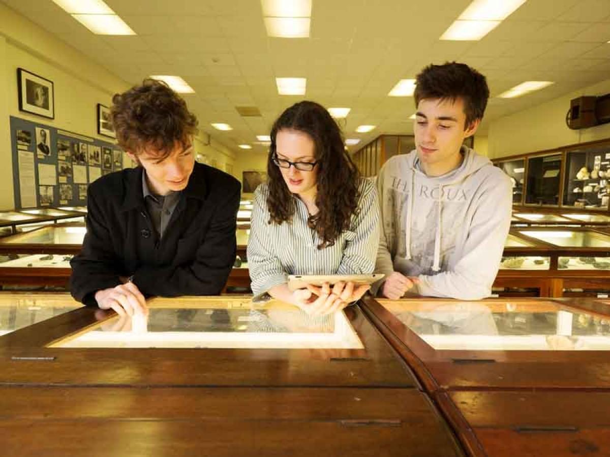 Three people looking at the Tate collection