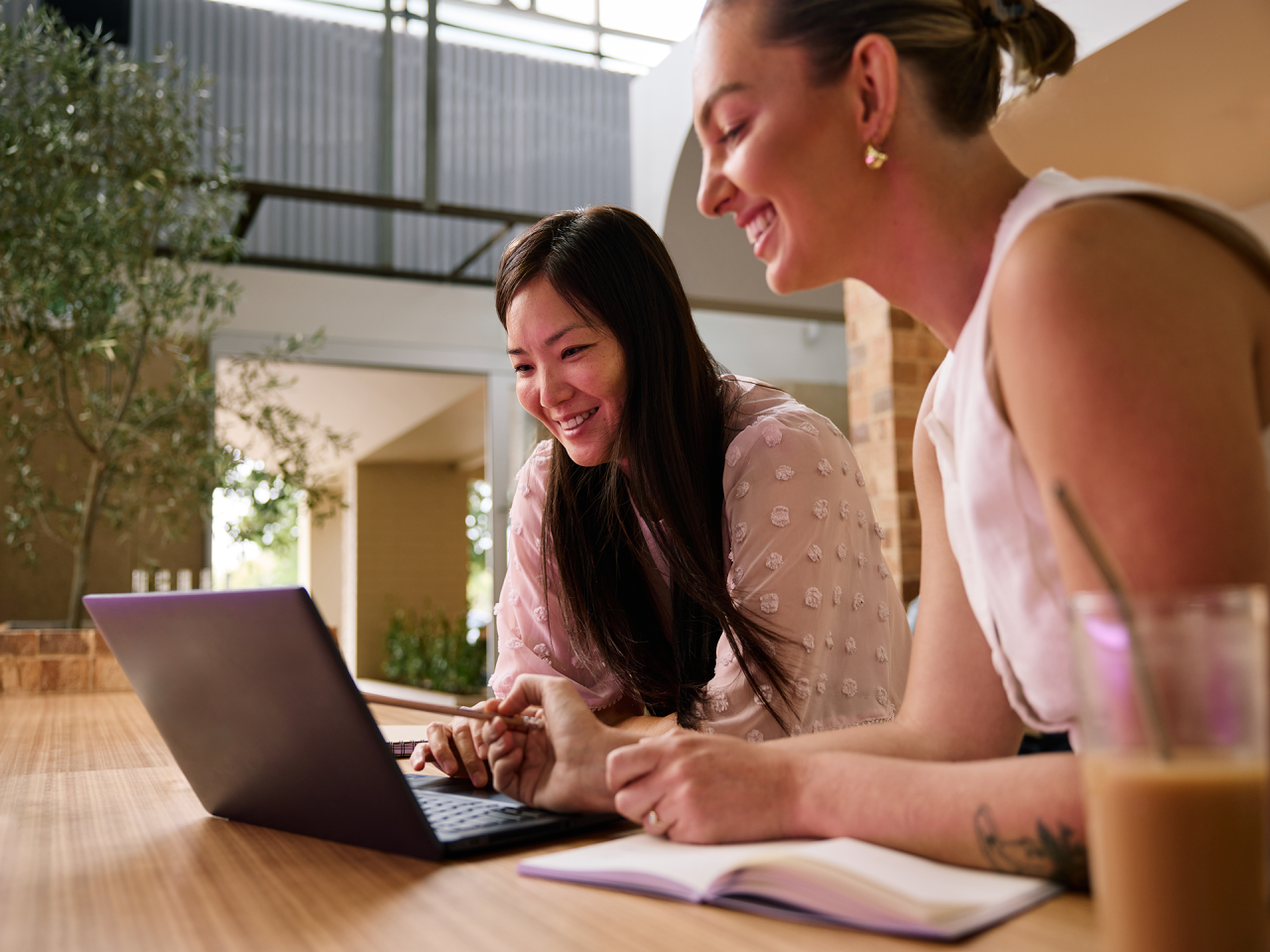 student on a couch with laptop